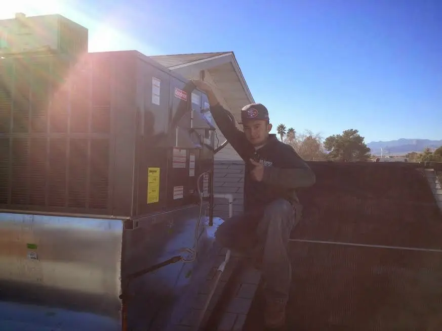 HVAC technician performing Heat Pump Repair on a rooftop unit in South Barrington